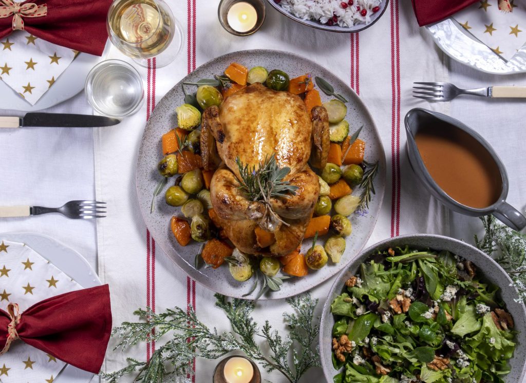 Whole Chicken in the Oven with Brussels Sprouts and Pumpkin served on a festive table